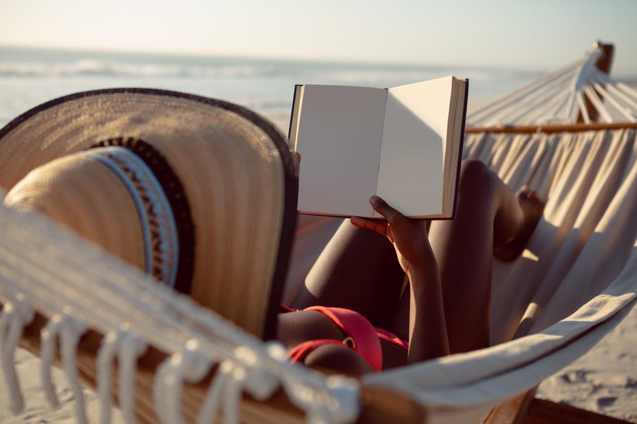 woman-reading-book-while-relaxing-hammock-beach.jpg