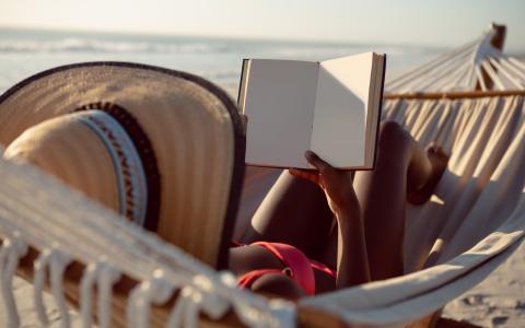 woman-reading-book-while-relaxing-hammock-beach.jpg